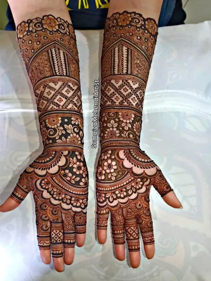 This photo shows the full bridal design against a simple background, which really helps the intricate patterns stand out. The symmetry between the two arms is key to a balanced look.
