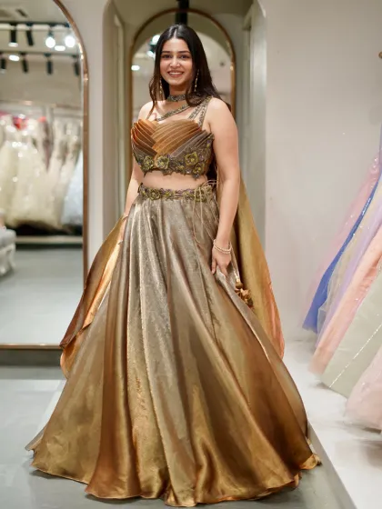 This outfit is pure 24k magic. A shimmering bronze and gold lehenga that catches the light beautifully, designed for a glamorous evening event.