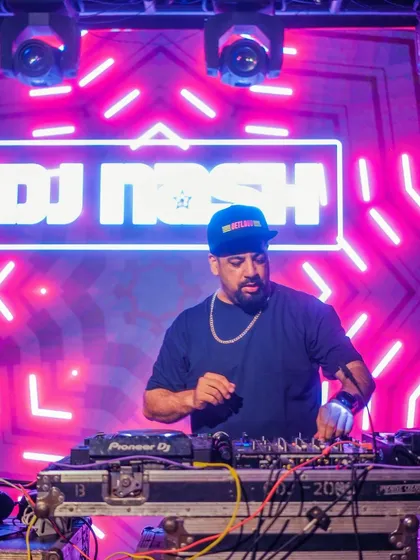 A close-up of me at the console with a cool neon background.