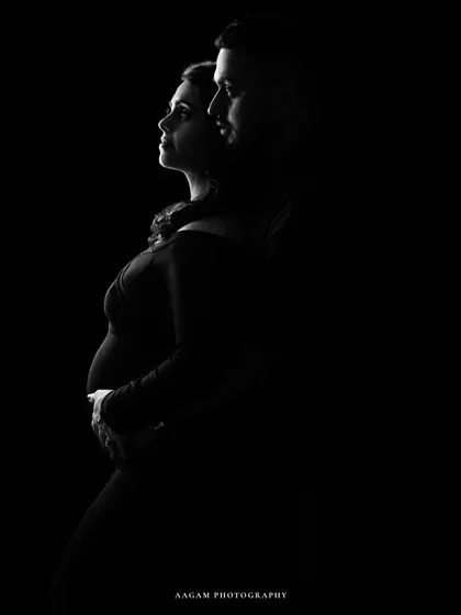 A low-key silhouette of a couple, their profiles gently lit. It's an intimate and artistic portrait of their shared journey.