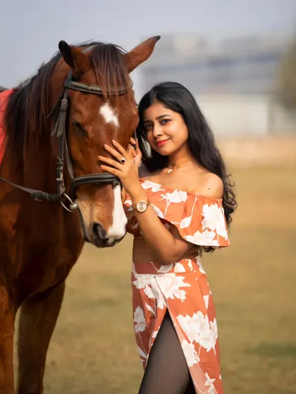 A close-up portrait that captures the gentle nature of the horse and the model's serene expression.