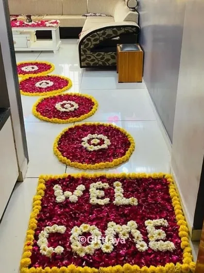 A warm welcome starts at the doorstep. I design beautiful flower rangolis using fresh marigold, rose, and jasmine petals to greet your guests. This 'WELCOME' mat design is a popular choice for making any entrance feel special and traditional.