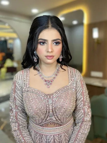 The makeup features a soft purple smoky eye.