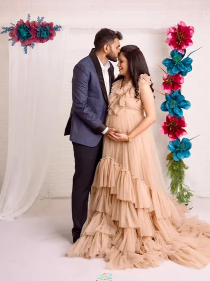A full-length view of this dreamy couple's portrait. The flowing, multi-layered gown creates a fairytale feel for their maternity photos.