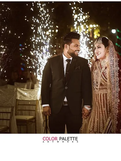 A magical wedding portrait with sparklers in the background. This kind of shot adds a celebratory and dramatic flair to the couple's reception photos.