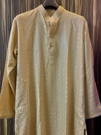 The same beige custom kurta shown in its full form. You can see the full-sleeve design and the comfortable, tailored fit that I create for each client.