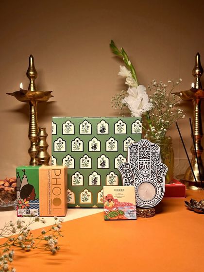 Spreading joy, one "upahar" (gift) at a time. This eco-friendly Diwali hamper features a Hamsa hand candle holder and products from Phool in a beautiful green gift box.