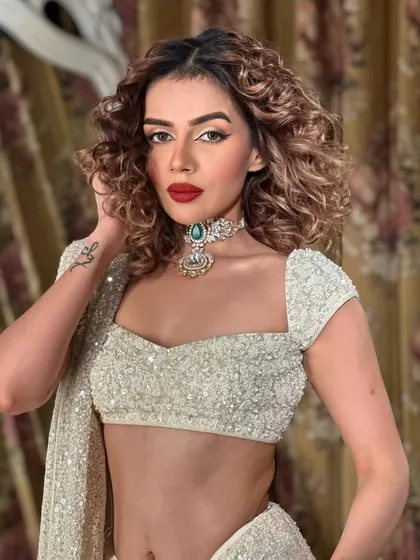 A close up on the flawless makeup. The skin is glowing and the red lip is perfectly applied.