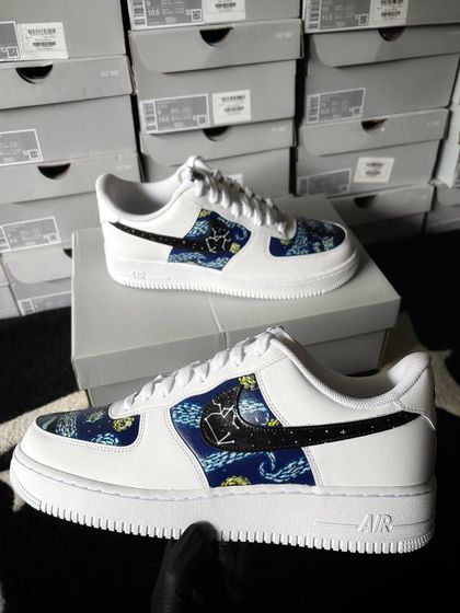 A full view of the galaxy custom sneaker held up.