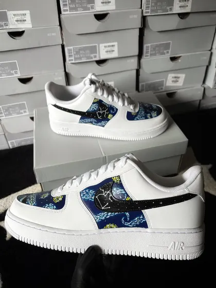 A full view of the galaxy custom sneaker held up.