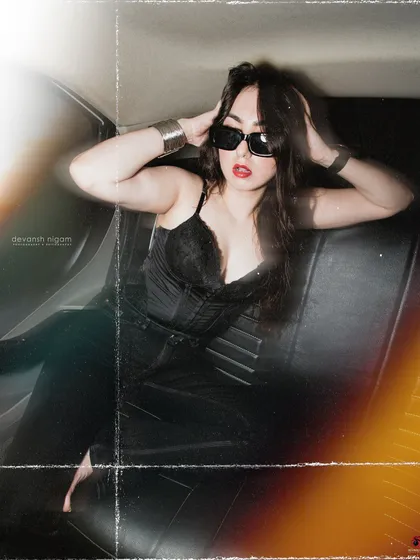 A full-body pose in the backseat of the car, capturing the high-fashion, editorial feel of the shoot.