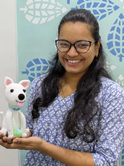 Here I am with Toby, a custom pet portrait I crocheted. It's so rewarding to bring your furry friends to life in yarn.