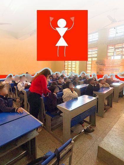 A teacher and a fellow collaborate during a classroom session. We work closely with school staff to integrate our methods and ensure a lasting impact.