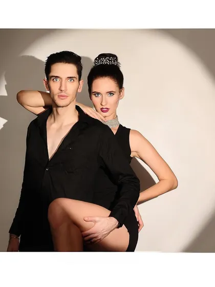 A dynamic and powerful pose from the spotlight couple shoot, conveying confidence and a strong connection between the subjects.