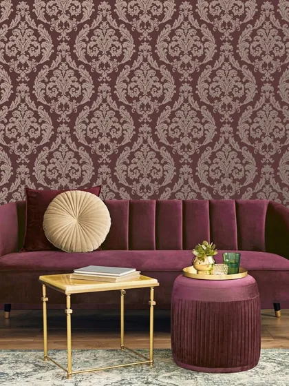 This setting showcases the timeless grandeur of classic design. The walls feature our Palazzo II damask wallpaper, its opulent pattern perfectly echoed in the rich, deep red velvet of the curved sofa, creating a cohesive and powerful statement.
