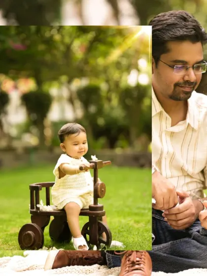 A beautiful family moment captured outdoors, with the baby on a wooden tricycle. The sunlight filtering through the trees adds a magical touch to the photo.