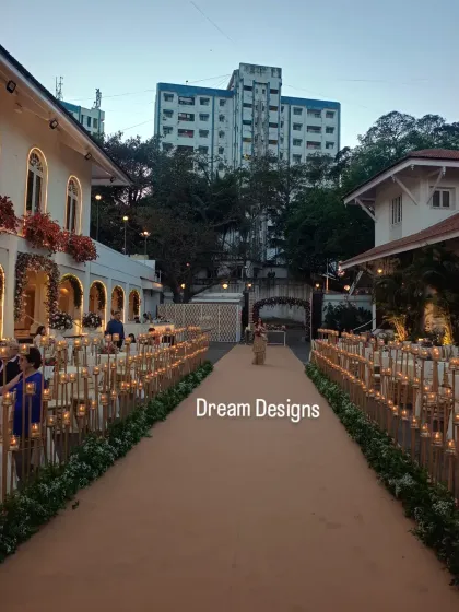 To create a dreamy and sacred ambiance, I lined the main walkway with hundreds of twinkling tealights on bamboo stands. This path of light guides guests through the space and adds a warm, intimate glow.