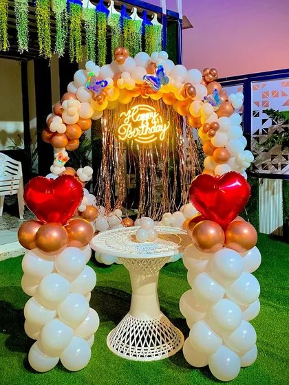 Here’s a beautiful outdoor birthday setup I did. The circular balloon arch in white and bronze, a shiny backdrop, and a custom neon "Happy Birthday" sign create a perfect photo corner for any party. I can customize the colors to match your theme.