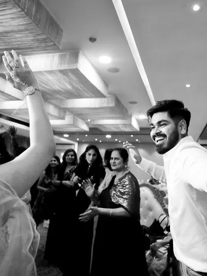 A happy, candid moment of the groom dancing with guests at the after-party.