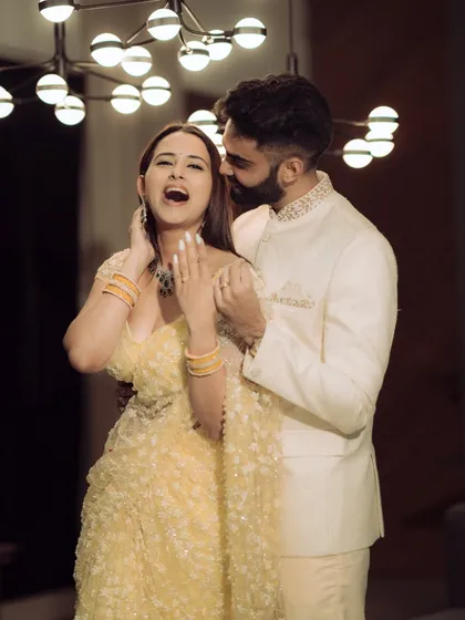 A joyful and candid shot from a Mumbai engagement shoot. The modern lighting and the couple's laughter create a vibrant and energetic image that perfectly captures the celebratory mood.