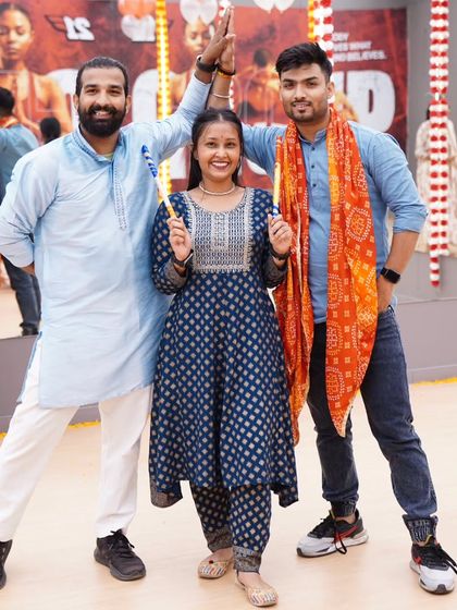 Posing with fellow instructors during our Dandiya event. We love bringing these cultural celebrations to the fitness world, making workouts feel like a festival.