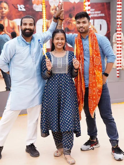 Sharing a moment with fellow dancers during a Dandiya night. The energy is built on teamwork and a shared love for dance.