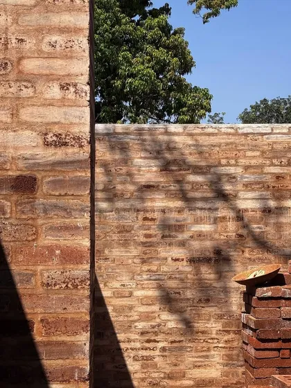 The stabilized earth block walls of Aadi Villa begin to rise. The blocks, made from local soil and construction debris, create a beautiful, layered texture while minimizing the project's carbon footprint.