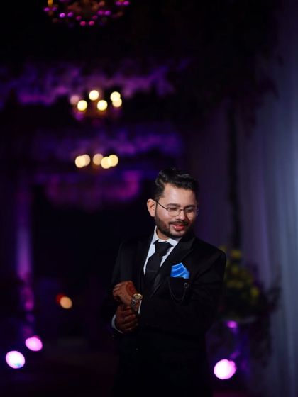 Another stylish shot from the reception. The focus is on the groom's sharp silhouette and polished appearance.