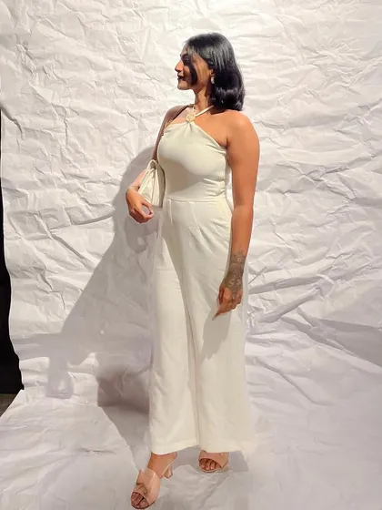 A sleek and simple white halter-neck jumpsuit. This is a perfect example of a one-and-done outfit that looks incredibly chic and polished for any formal event.