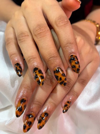 The details matter. Here's a closer look at the precision and quality of our hand-painted cheetah print nail art, showing the glossy finish and clean lines.
