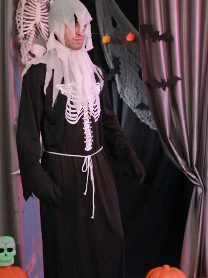 Become a creature of the night with this skeleton grim reaper costume. The printed skeleton bones and hooded robe create a classic and terrifying look for any Halloween event.
