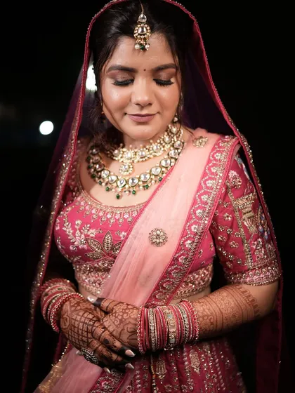 A close-up portrait of the bride, her eyes closed, showcasing the beautiful eye makeup.