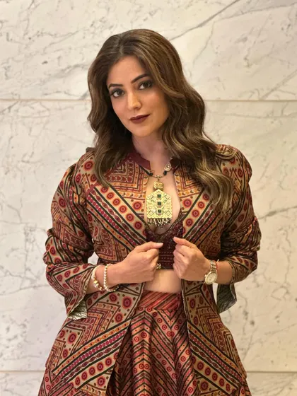 The brown tones in her hair are highlighted beautifully by these soft waves. It's a versatile look that's both casual and chic.