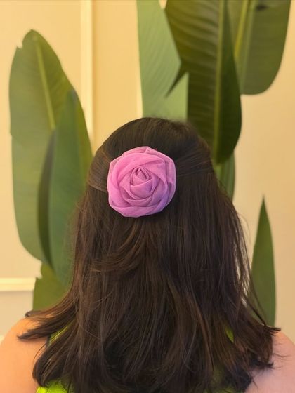 A delicate organza rose clip in a lovely lavender shade, perfect for a soft, romantic hairstyle.
