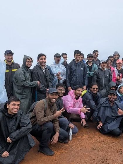 A large group of trekkers in ponchos, united by the rain and the trail. We believe in the power of shared experiences to bring people together, no matter the weather.
