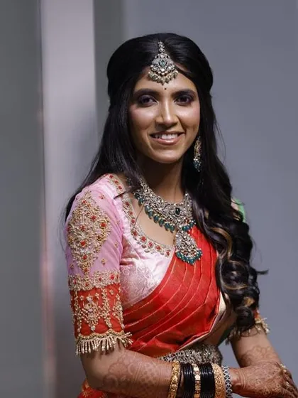 Our client looks stunning in this Victorian-style set with green stones. The layered necklace and matching vaddanam create a complete and elegant look.
