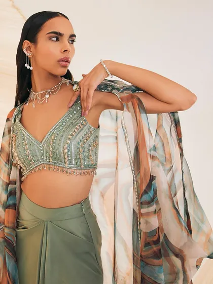 A closer look at the Vivien Cape Set, showing the delicate embellishments on the silky organza cape and the tassel details on the blouse.