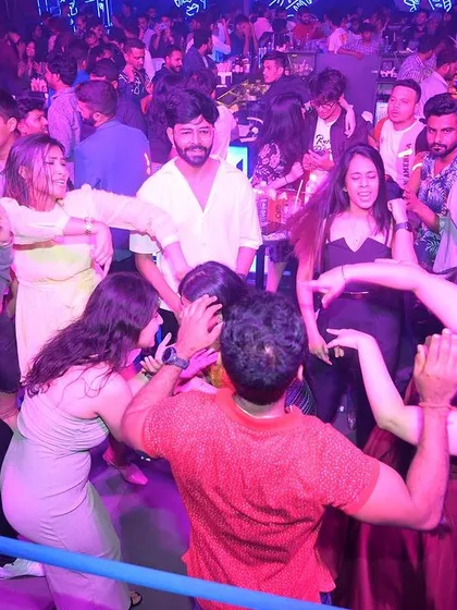 The crowd dancing in a circle, creating their own party within the party.