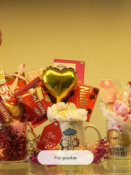 A fun and quirky hamper for your 'pookie'. This gift is a chaotic but loving mix of chocolates, snacks, a heart-shaped balloon, and cute mugs, perfect for celebrating a fun-loving relationship.