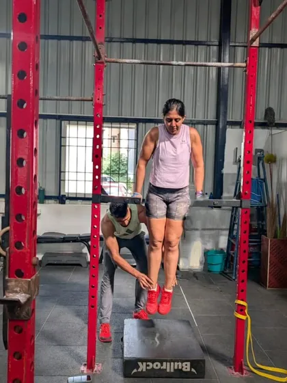 My coaching philosophy is simple: mechanics, consistency, then intensity. Here, I'm providing hands on support to help a client master the mechanics of a bar dip, ensuring she builds strength on a solid foundation of proper form.