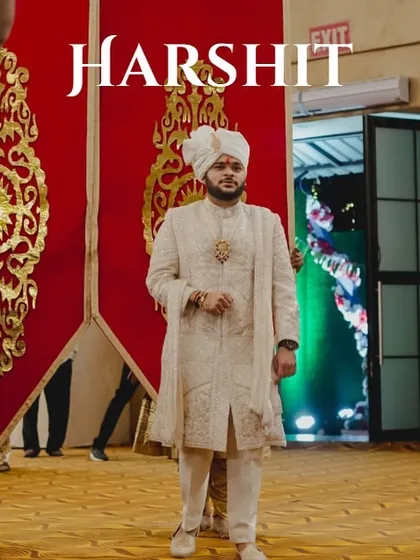 A royal entrance for the groom. He stands poised between grand red banners before walking towards the mandap, a moment of anticipation I love to build.