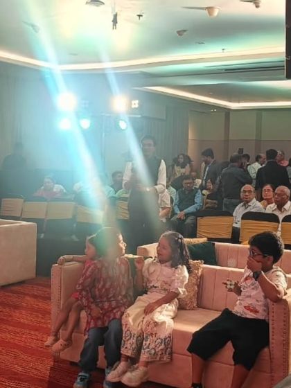 A candid shot of the audience, with children and adults enjoying the live music from comfortable lounge seating. We work with you to ensure the performance is engaging for guests of all ages.