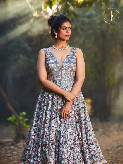 An ethereal and elegant floral gown. The plunging neckline and A-line silhouette are incredibly flattering, making this a beautiful choice for a formal dinner, engagement party, or a sophisticated evening event.