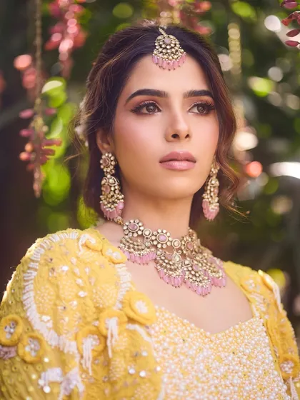 A beautiful portrait of Bhumika. The soft pink makeup enhances her features without overpowering her natural beauty.