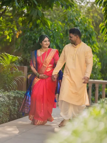 A beautiful walking shot of Jagruti and Shubham in their traditional attire. The movement and natural interaction make the photo feel alive and candid.