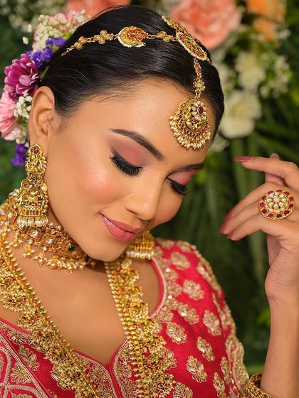 A close-up on the soft pink eye makeup and the beautiful floral bun. This look is all about romantic details and creating a fresh, youthful glow.