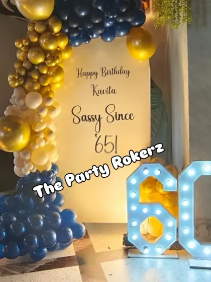 The full setup for the 60th birthday, including the custom backdrop, balloon arch, and large light-up marquee numbers, creating a perfect photo opportunity.