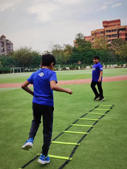 Two players work on separate ladder drills, showcasing our approach to simultaneous, efficient training. We ensure every player gets the repetitions they need to master their footwork and coordination.