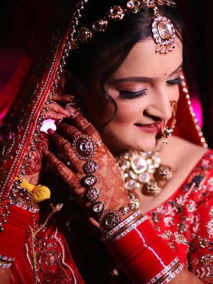 A candid shot of my bride Swati adjusting her earring. Her smile and the details of her henna look so beautiful.