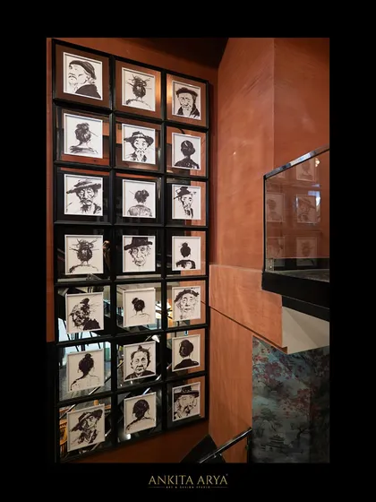 A gallery wall of custom-illustrated portraits, created to add a personal and artistic touch to a corner of the Shanghigh restaurant.